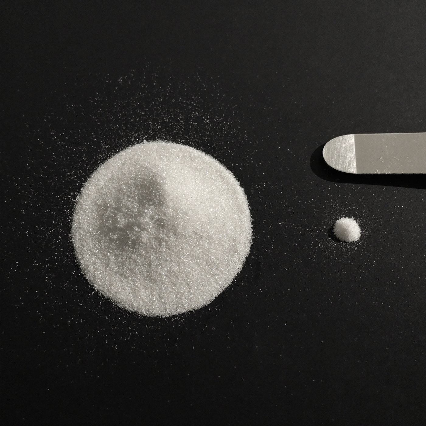 Two measured mounds of powder, one ten times the size of the other